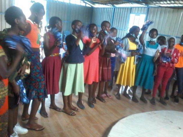Young women who had been using old clothes and rags receiving new soft, absorbent, reusable cloth menstrual pads.